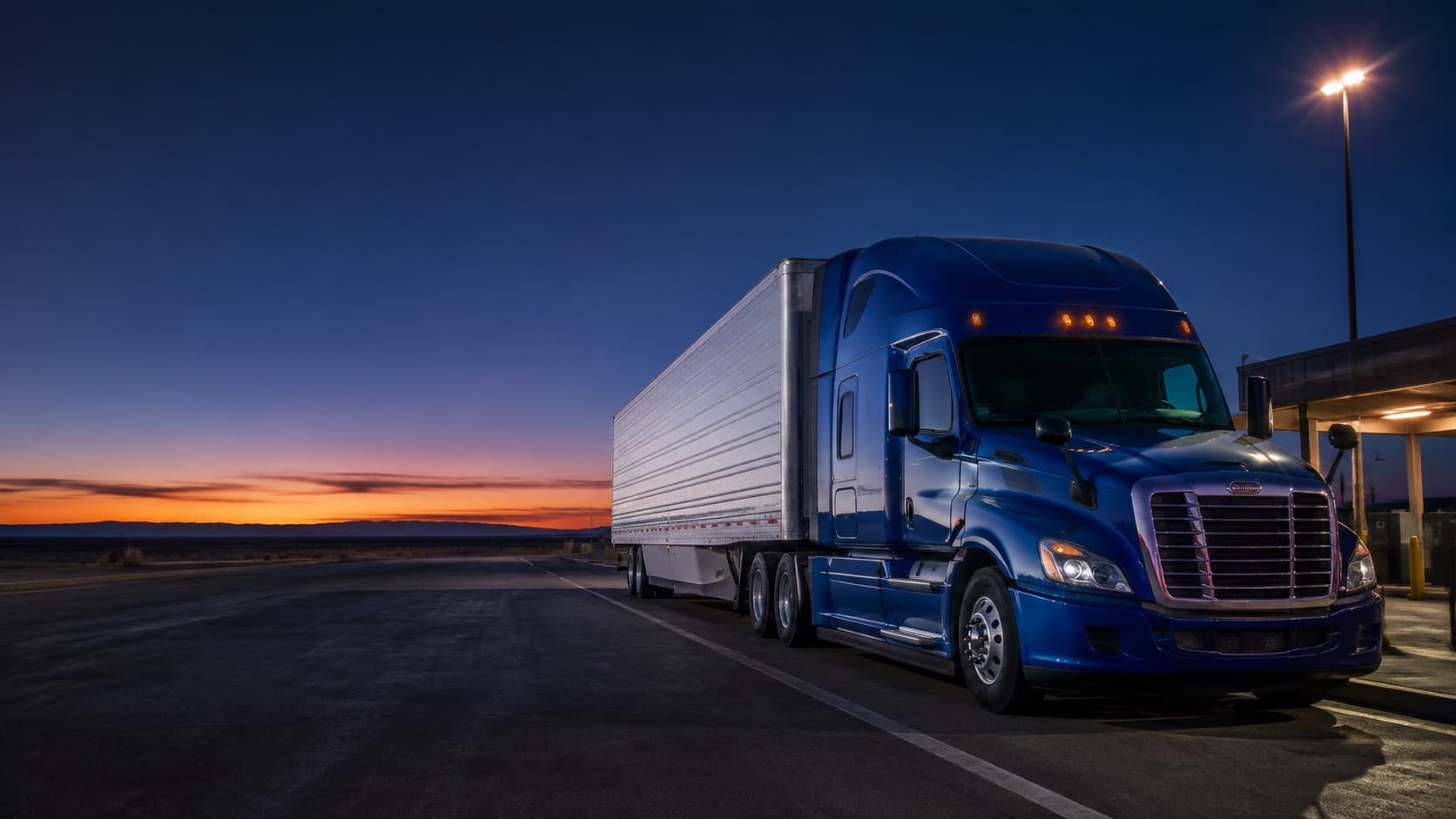A blue semi truck and trailer ready for the next load